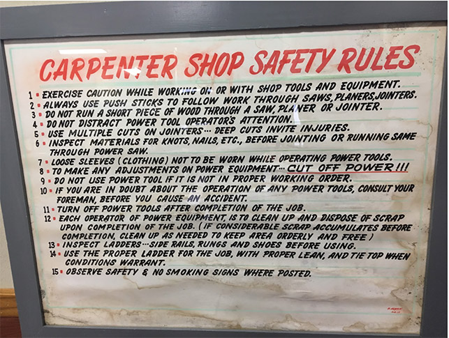 This safety sign—now displayed in the Urton Clock House Museum—would have hung in the Carpenter Shop. Image taken by Research Team